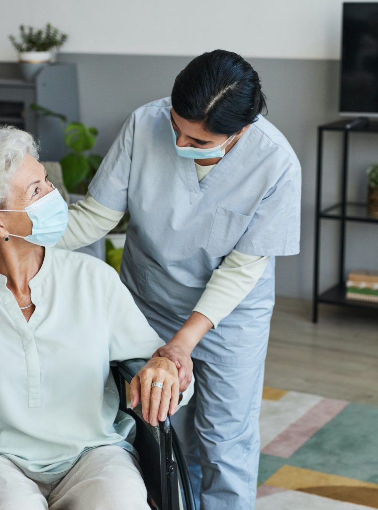 Caring Nurse Helping Senior in Wheelchair